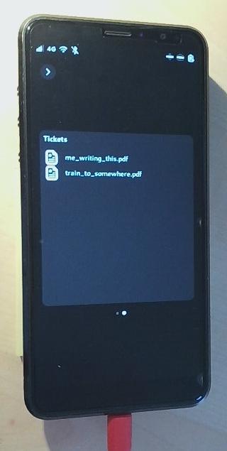 Librem5 showing the Phosh lockscreen running the phosh-ticket-box plugin showing a list with two files.
