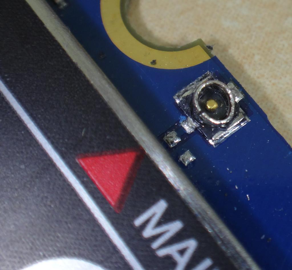 Picture of a small part of the bm818 modem card from a Librem5 showing the deformed and broken main antenna plug.
