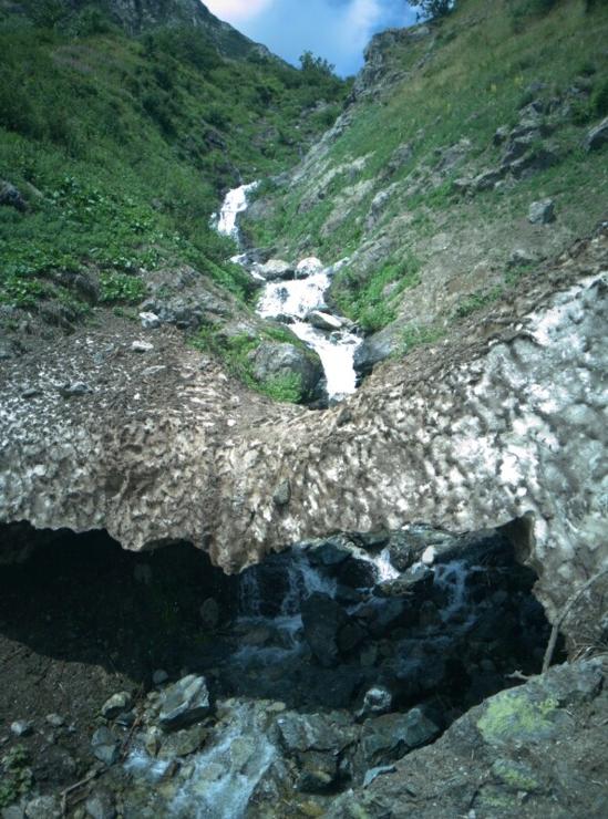 bridge of snow over a mountain stream