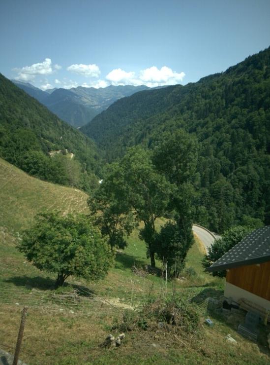 a road coming up from the valley, mountains in the background